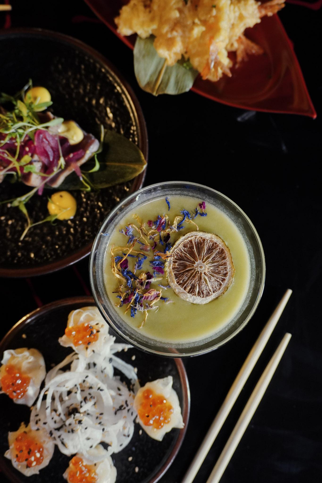 Citrus cocktail with dried lime and flowers.